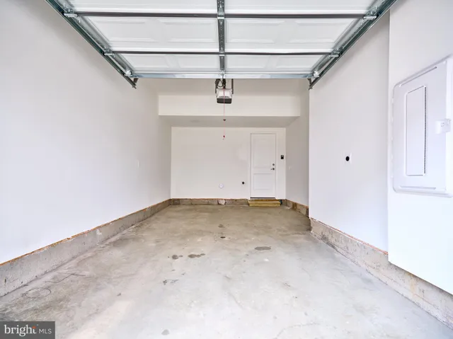 a view of a room with a ceiling fan and window
