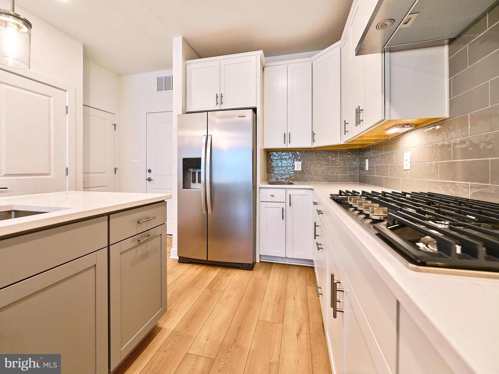 16076 Frederick Road Rockville, MD 20850 - Photo 5 of 30 a kitchen with granite countertop a sink stove and refrigerator