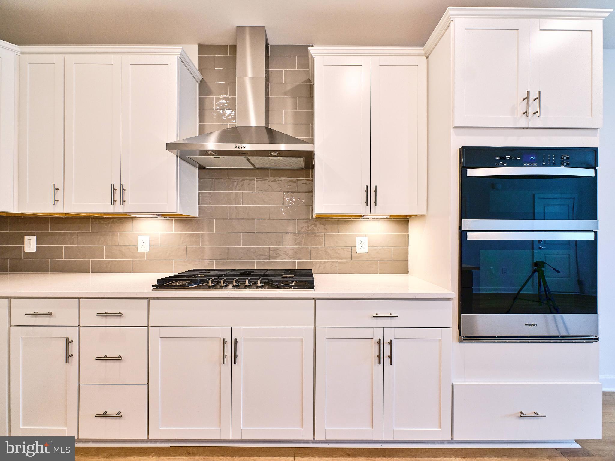 16076 Frederick Road Rockville, MD 20850 - Photo 6 of 30 a kitchen with granite countertop white cabinets and white appliances
