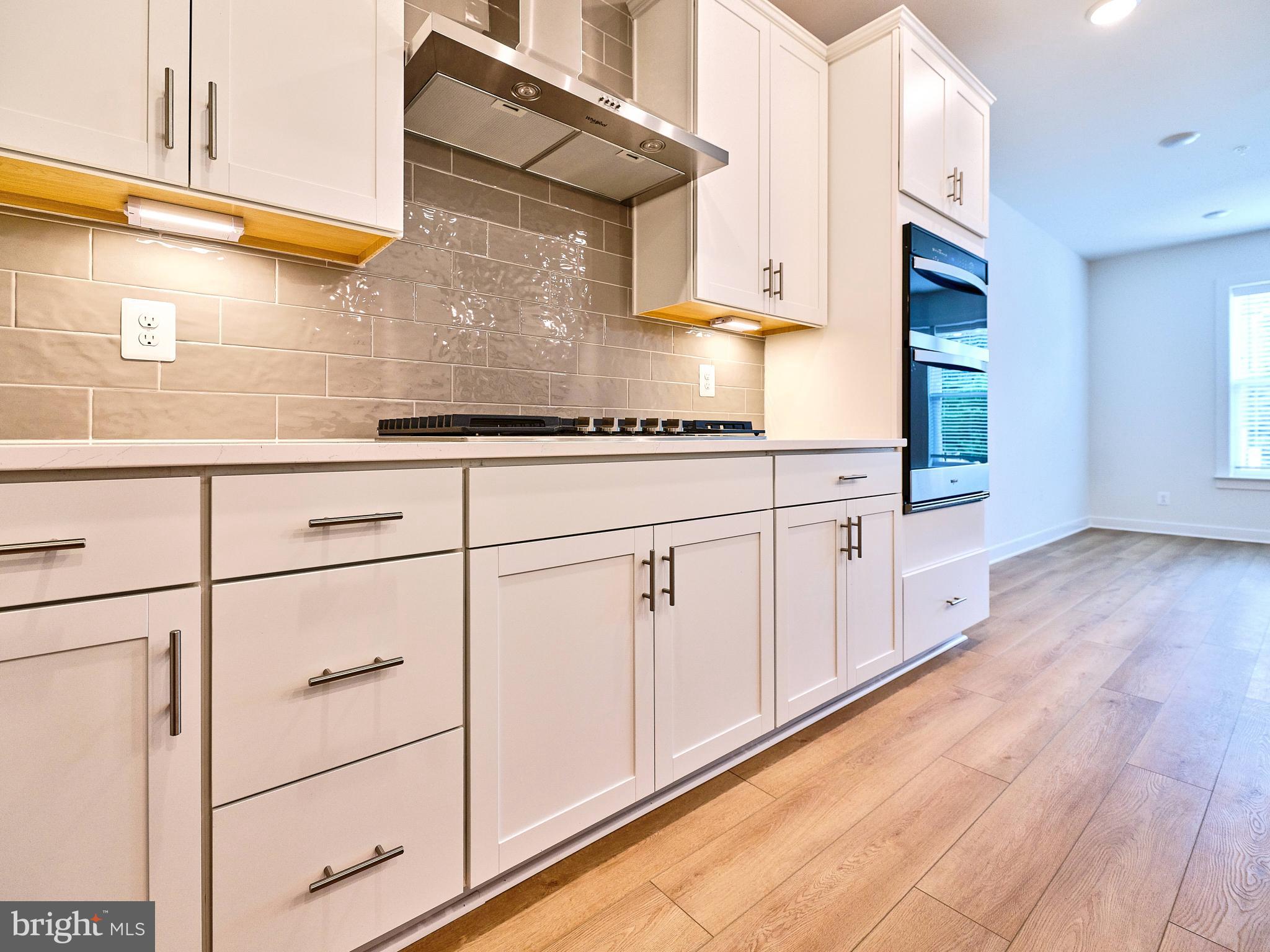16076 Frederick Road Rockville, MD 20850 - Photo 8 of 30 a kitchen with white cabinets and white appliances