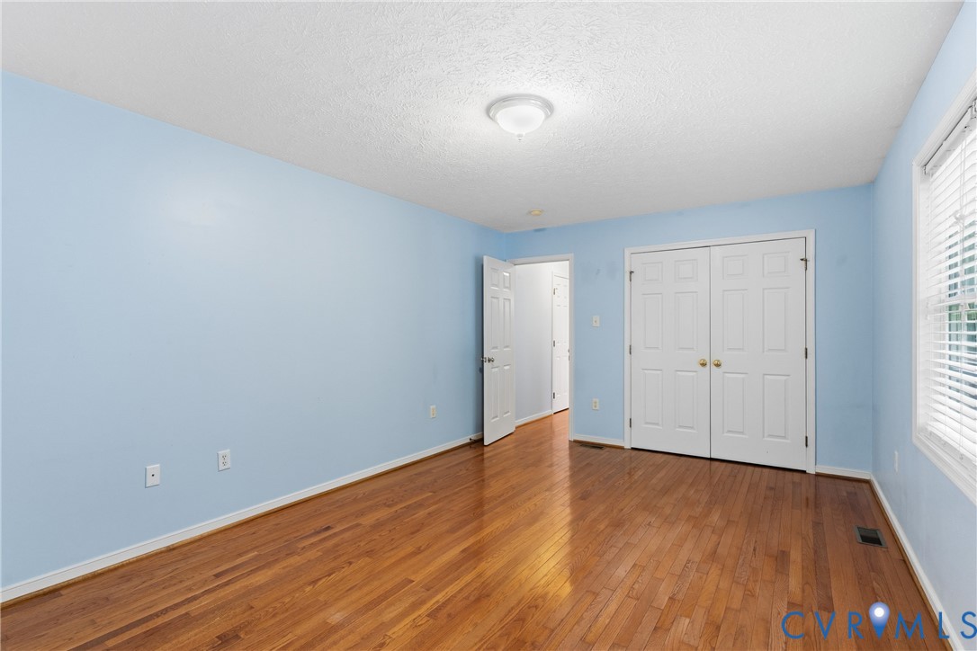 12654 Mt Olive Cohoke Road West Point, VA 23181 - Photo 18 of 31 a view of an empty room with wooden floor and window