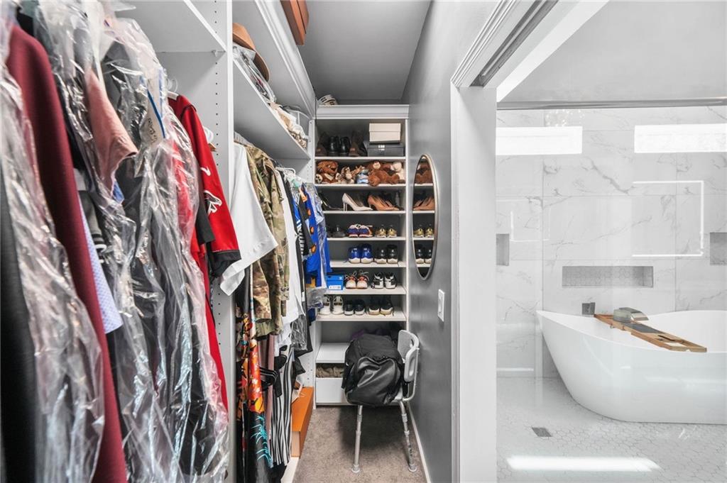 4835 Liberty Road Villa Rica, GA 30180 - Photo 25 of 69 a view of walk in closet with clothes and shoes
