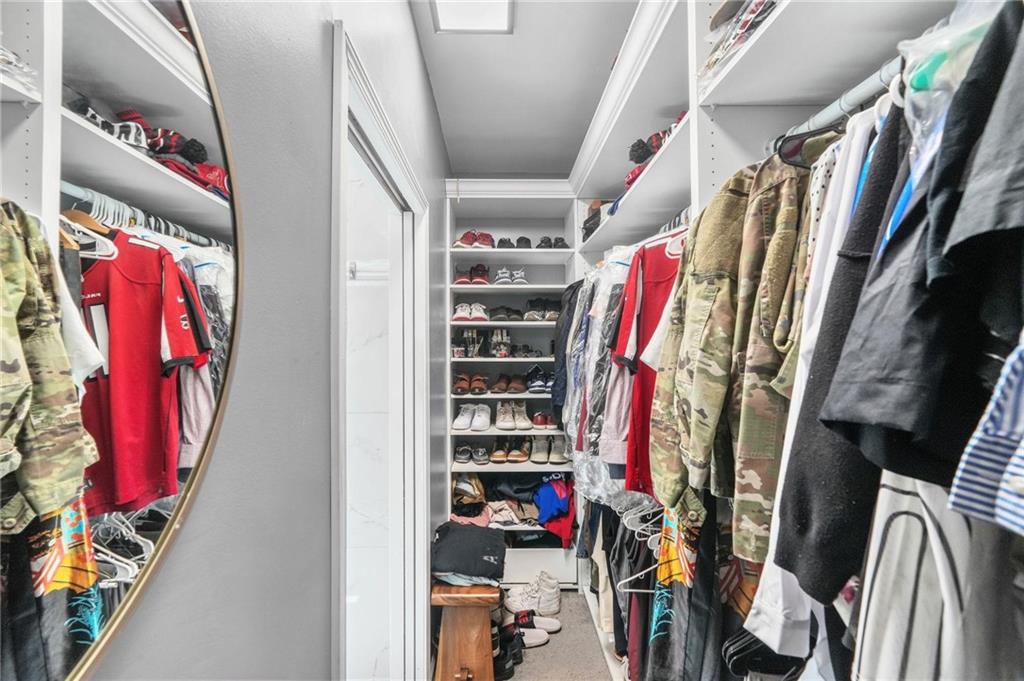 4835 Liberty Road Villa Rica, GA 30180 - Photo 26 of 69 a view of walk in closet with clothes and shoes
