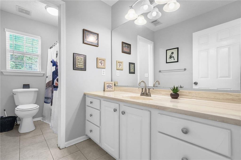 4835 Liberty Road Villa Rica, GA 30180 - Photo 33 of 69 a bathroom with a granite countertop sink mirror and toilet