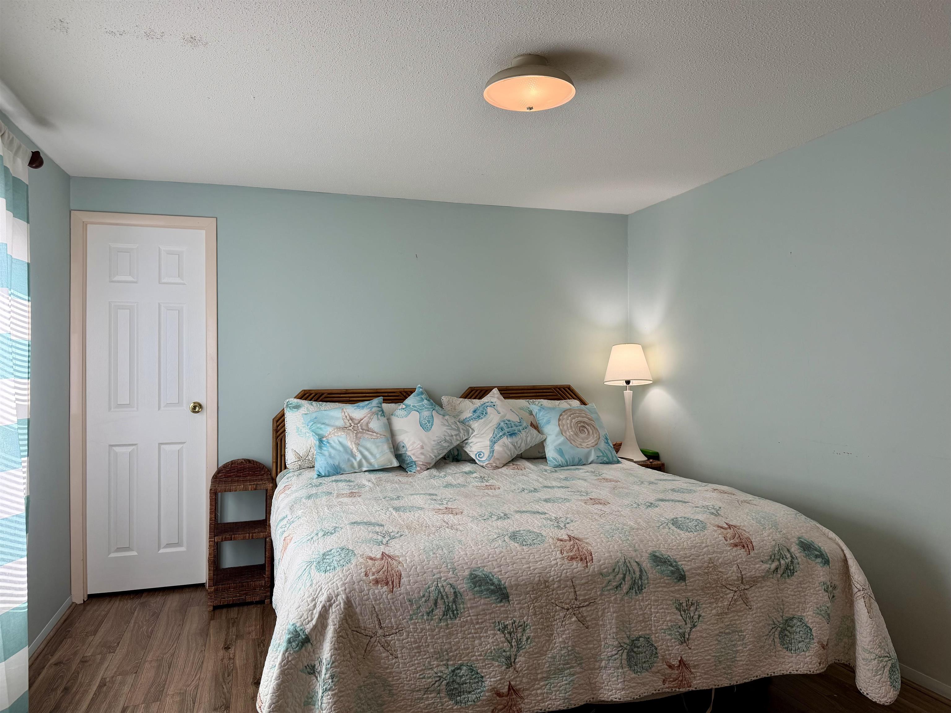 1980 Lark Surfside Beach, SC 29575 - Photo 13 of 30 Bedroom featuring dark wood-style flooring and a textured ceiling
