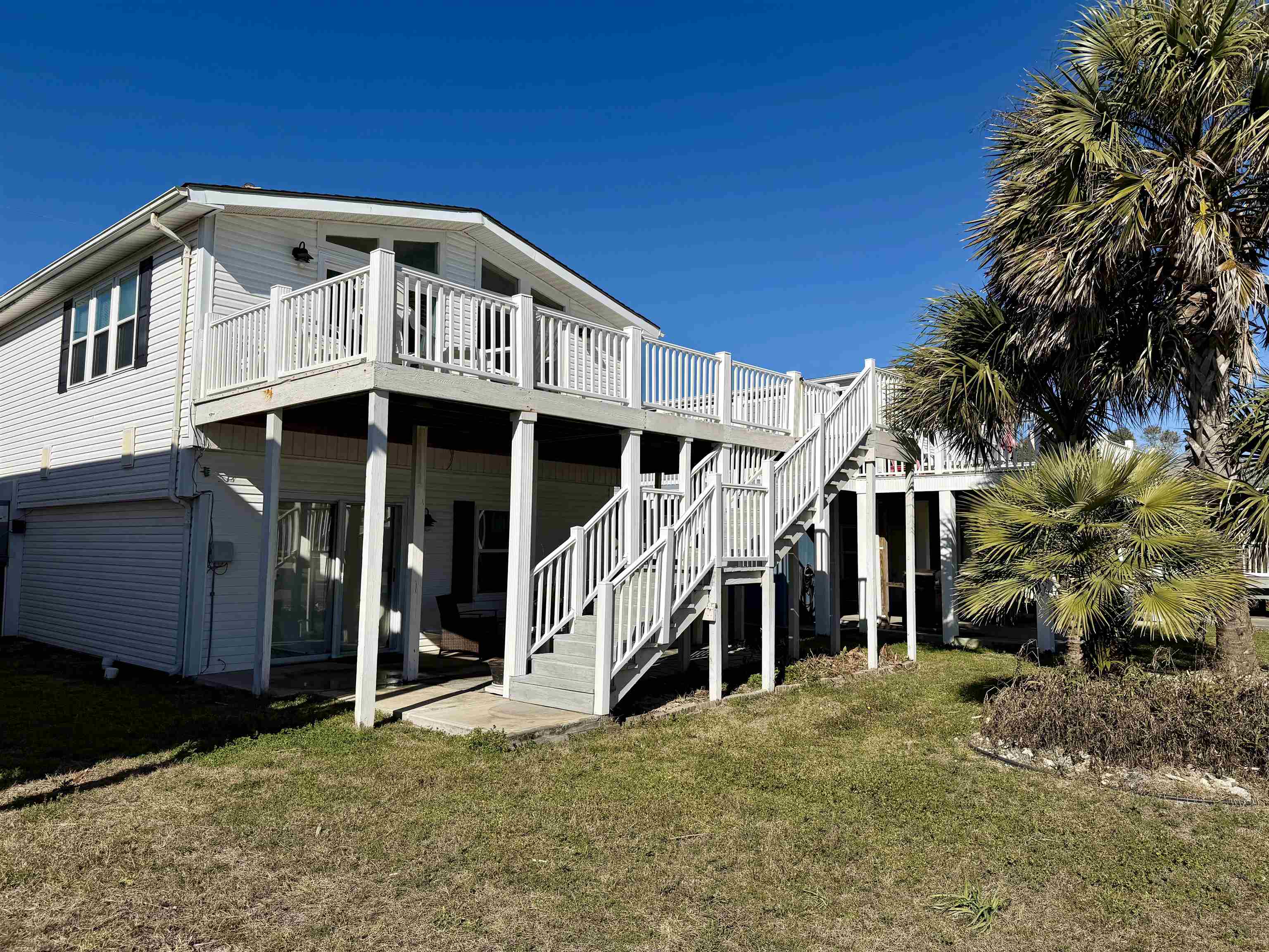 1980 Lark Surfside Beach, SC 29575 - Photo 19 of 30 Rear view of property featuring a deck, a yard, and stairway