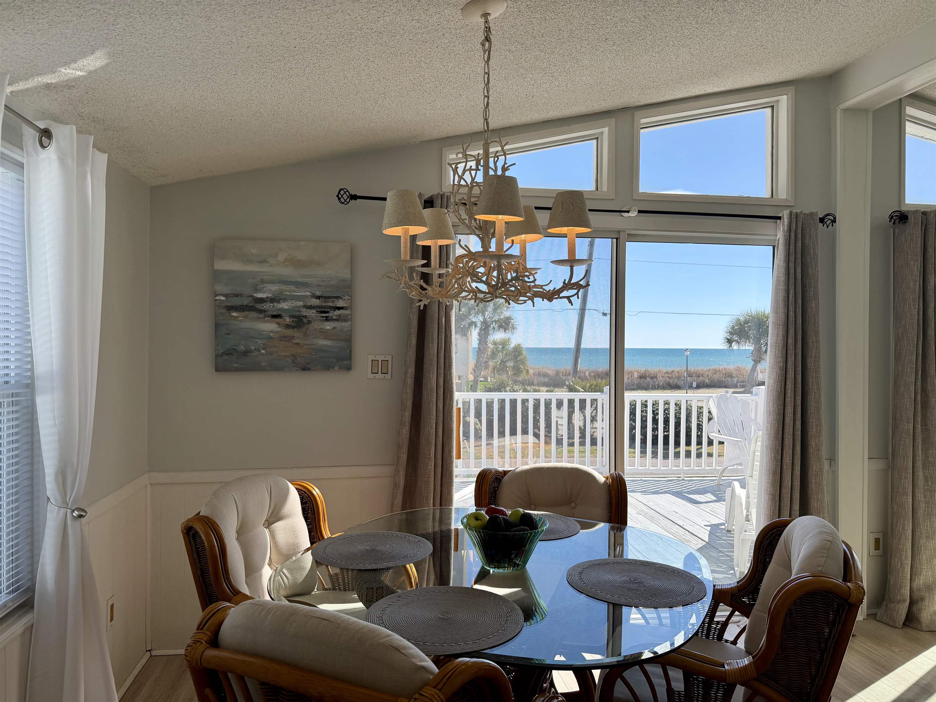 1980 Lark Surfside Beach, SC 29575 - Photo 5 of 30 Dining room featuring vaulted ceiling, a water view, wainscoting, a textured ceiling, and a chandelier