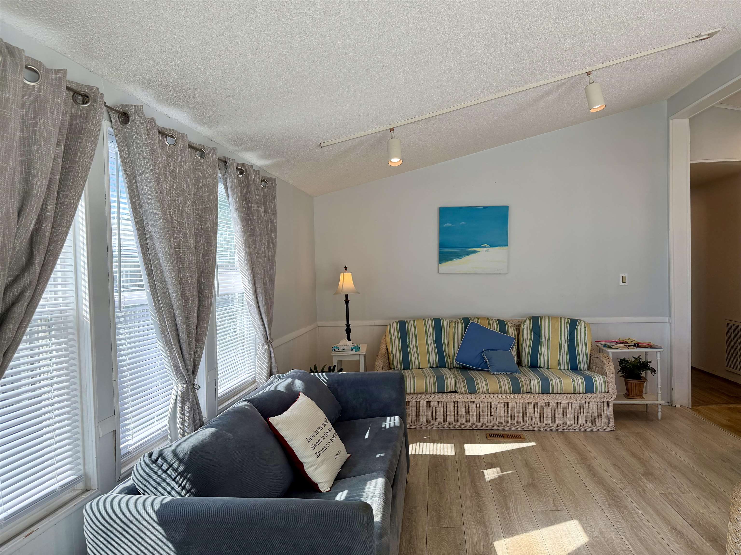 1980 Lark Surfside Beach, SC 29575 - Photo 10 of 30 Living room with vaulted ceiling, rail lighting, a textured ceiling, and wood finished floors