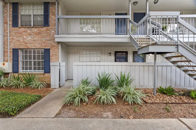 front view of house with potted plants