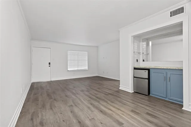 an empty room with a bathroom and mirror