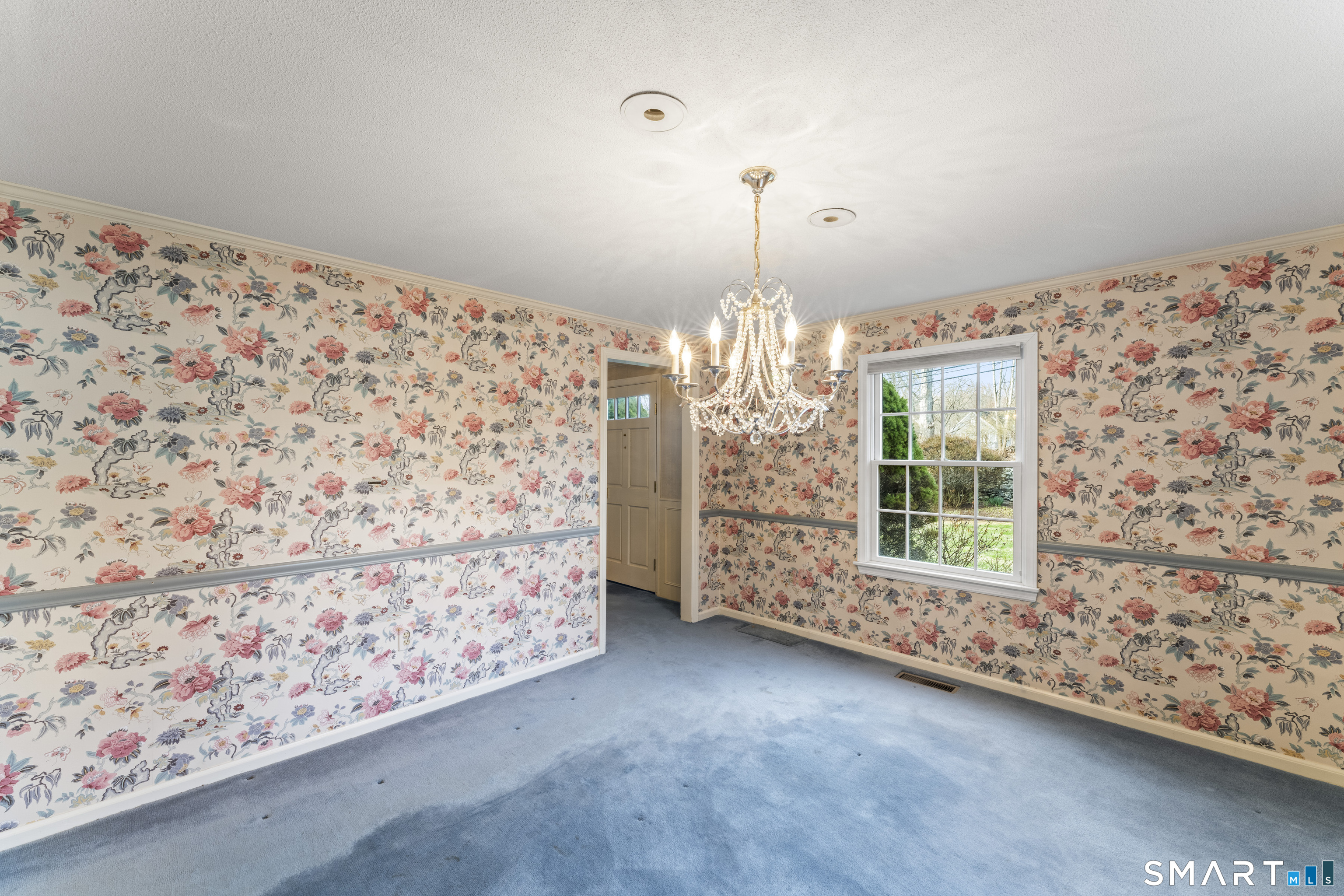 30 Currituck Road Newtown, CT 06470 - Photo 15 of 38 a view of a livingroom with a chandelier front door and wooden floor