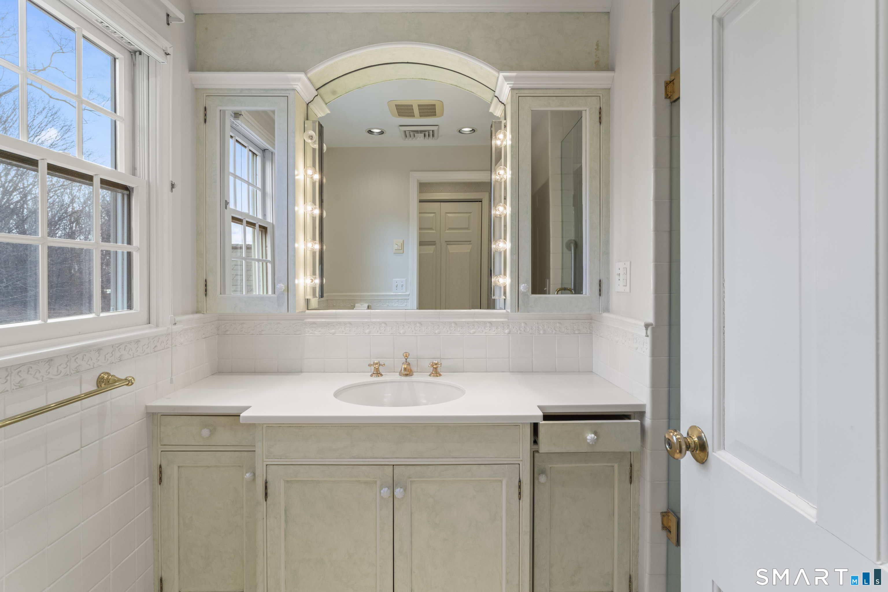 30 Currituck Road Newtown, CT 06470 - Photo 25 of 38 a bathroom with a sink and a mirror