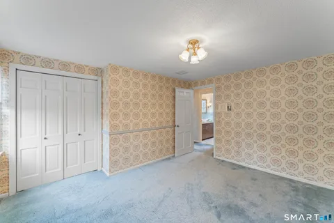 an empty room with windows and closet