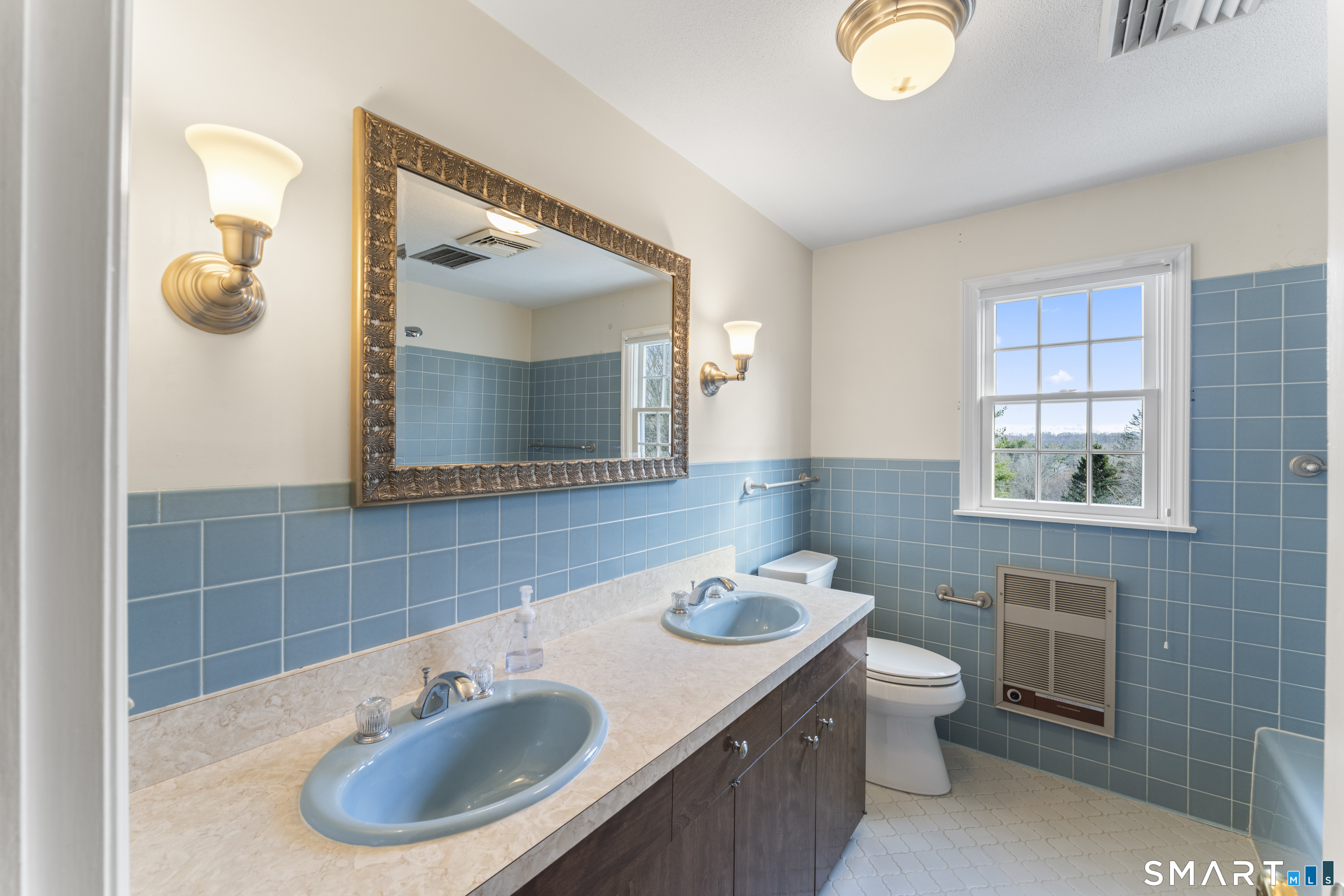 30 Currituck Road Newtown, CT 06470 - Photo 30 of 38 a bathroom with a sink and a mirror