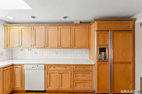 a kitchen with granite countertop cabinets and black stainless steel appliances
