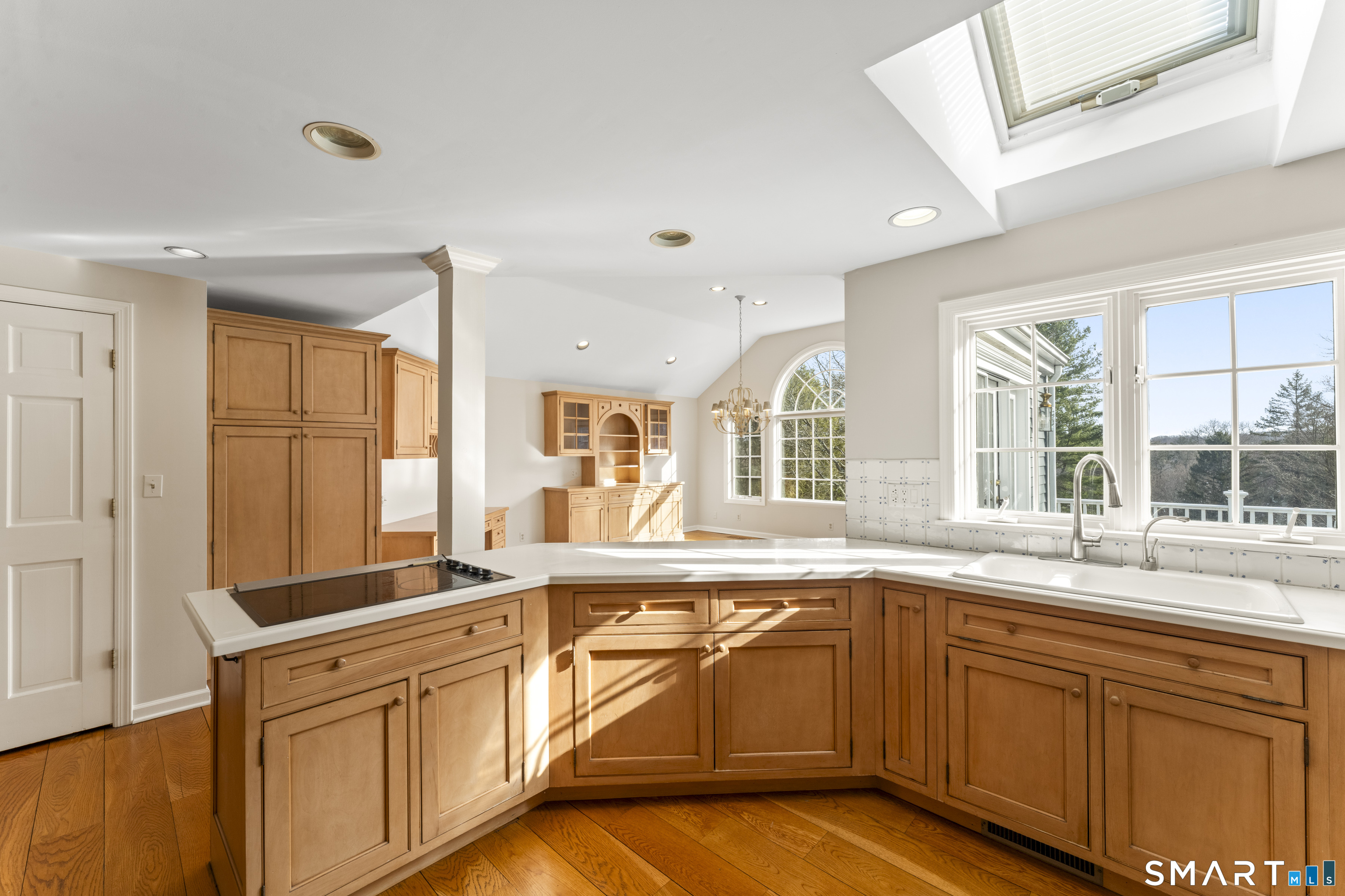 30 Currituck Road Newtown, CT 06470 - Photo 6 of 38 a kitchen with stainless steel appliances granite countertop a sink and cabinets with wooden floor