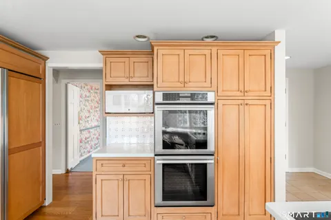 a kitchen with wooden cabinets and a stove top oven