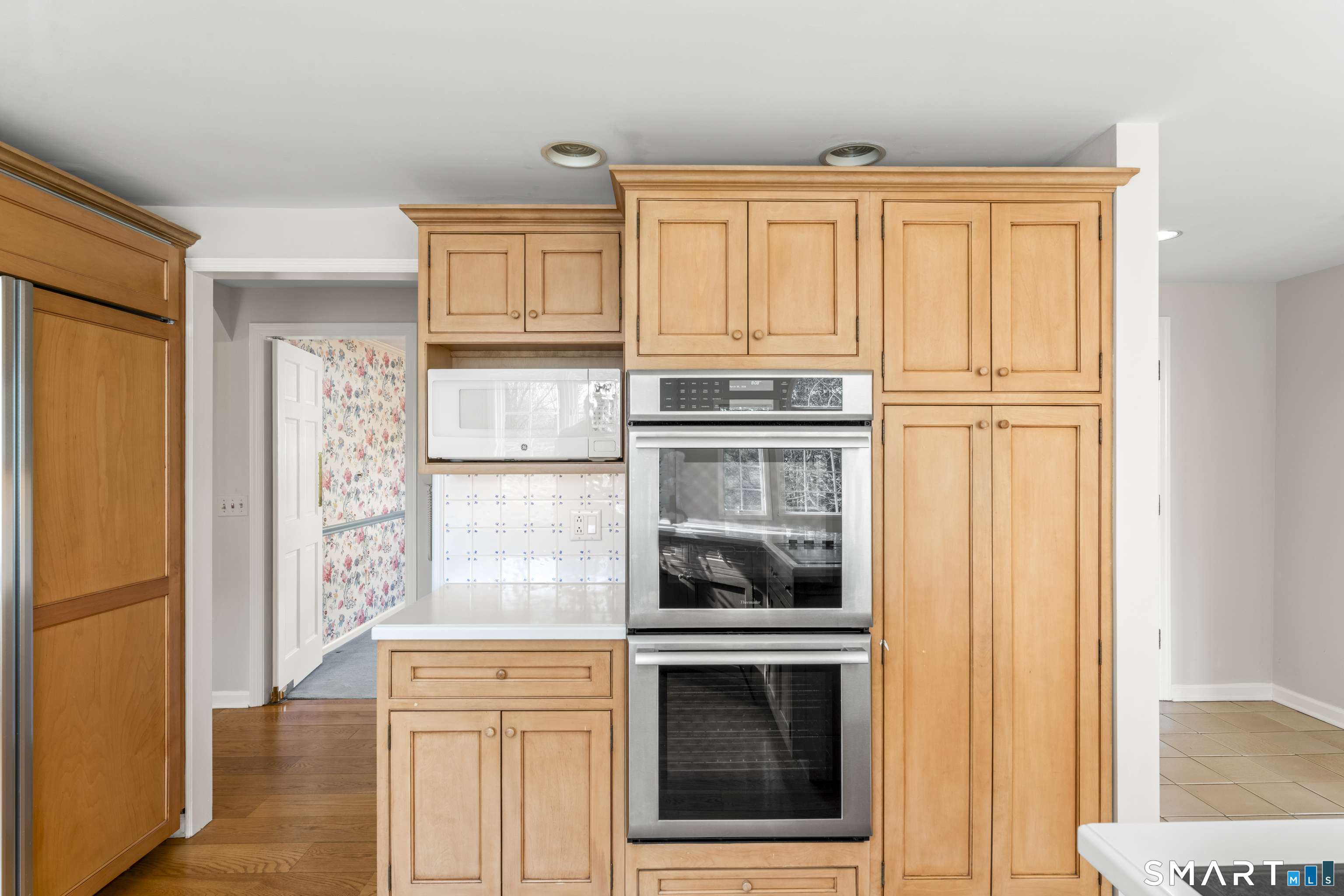 30 Currituck Road Newtown, CT 06470 - Photo 7 of 38 a kitchen with wooden cabinets and a stove top oven