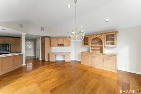 a large kitchen with kitchen island a sink stainless steel appliances and cabinets