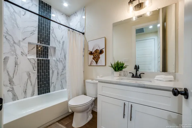 a bathroom with a sink toilet and shower