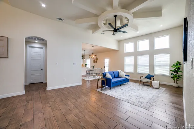 a living room with furniture and wooden floor