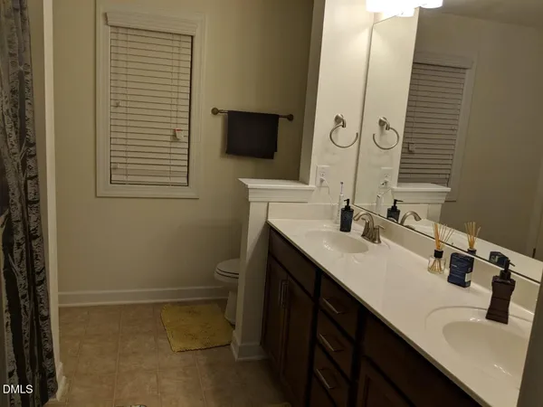 a bathroom with a sink double vanity and a mirror