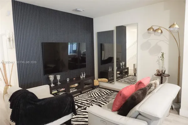 a living room with furniture and a flat screen tv