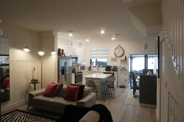 a living room with furniture and a glass door