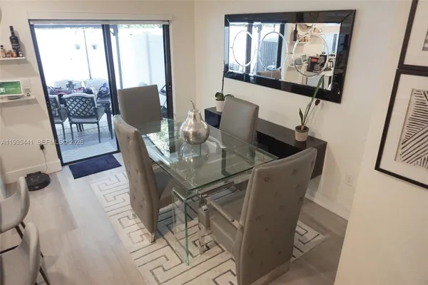 a dining room with furniture and wooden floor
