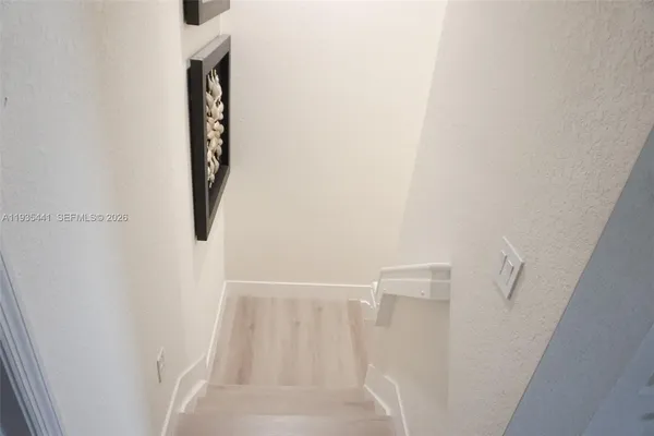 a view of entryway and hall with wooden floor