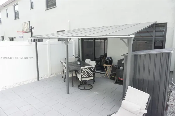 a dining room with furniture and a window