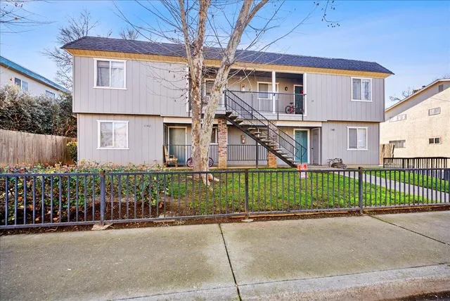 a front view of a house with a garden