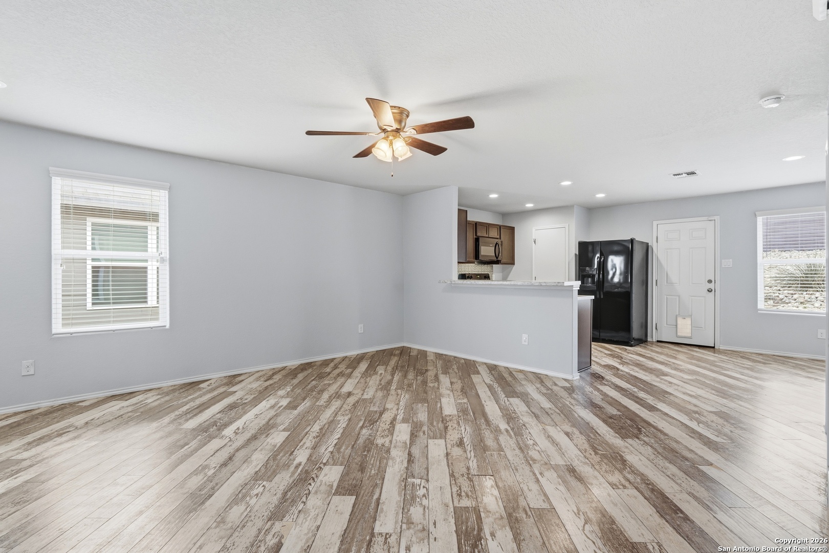 9713 Sandy Rdg Way San Antonio, TX 78239 - Photo 12 of 39 a view of empty room with wooden floor and ceiling fan