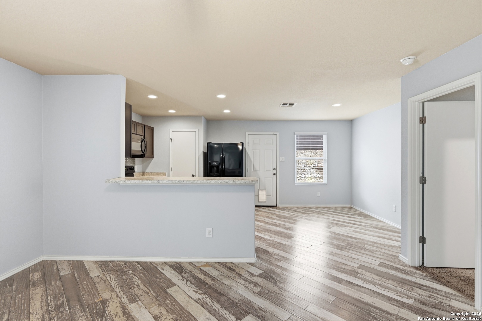 9713 Sandy Rdg Way San Antonio, TX 78239 - Photo 14 of 39 a view of kitchen with cabinets and wooden floor