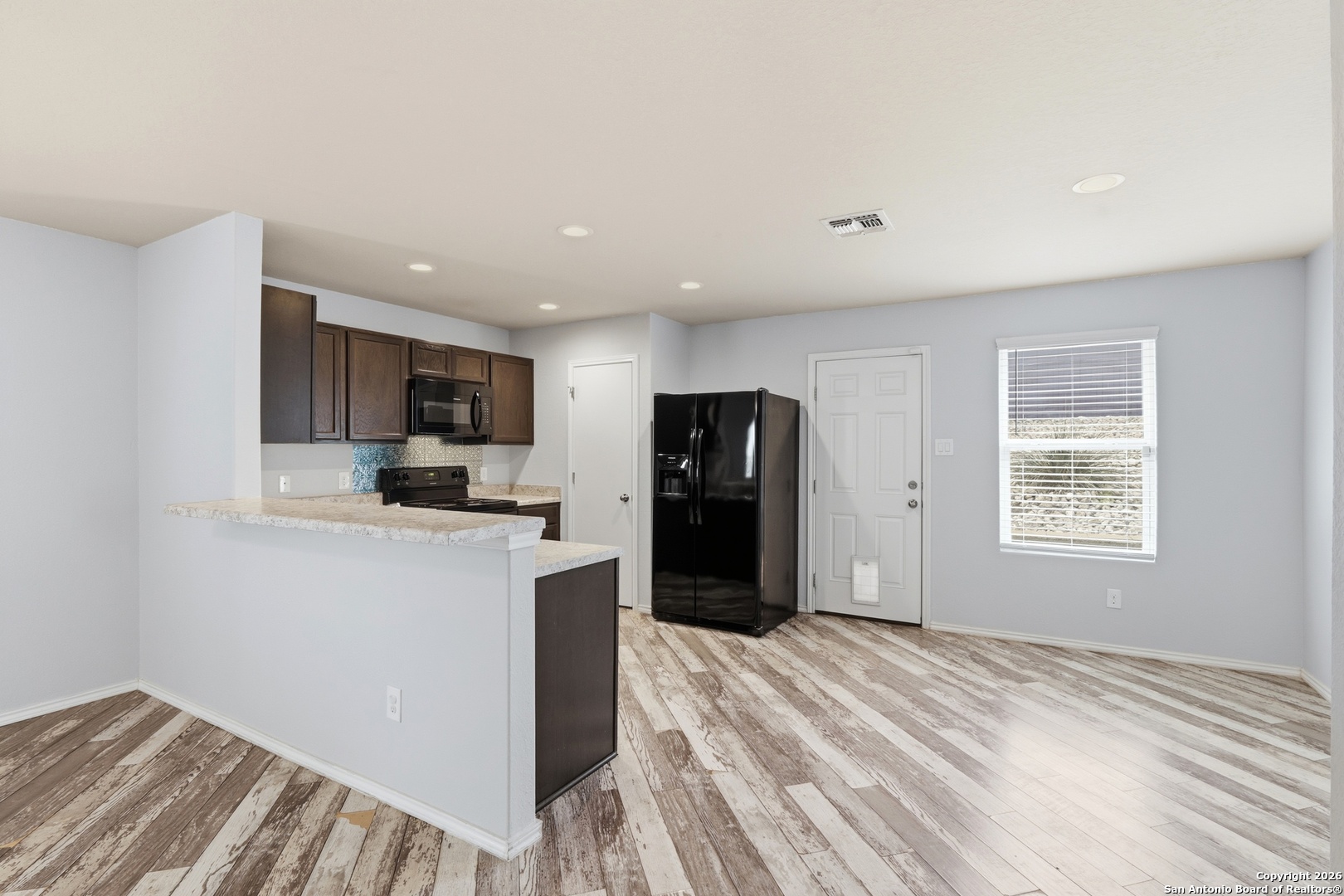 9713 Sandy Rdg Way San Antonio, TX 78239 - Photo 15 of 39 a kitchen with stainless steel appliances granite countertop a refrigerator and a stove top oven