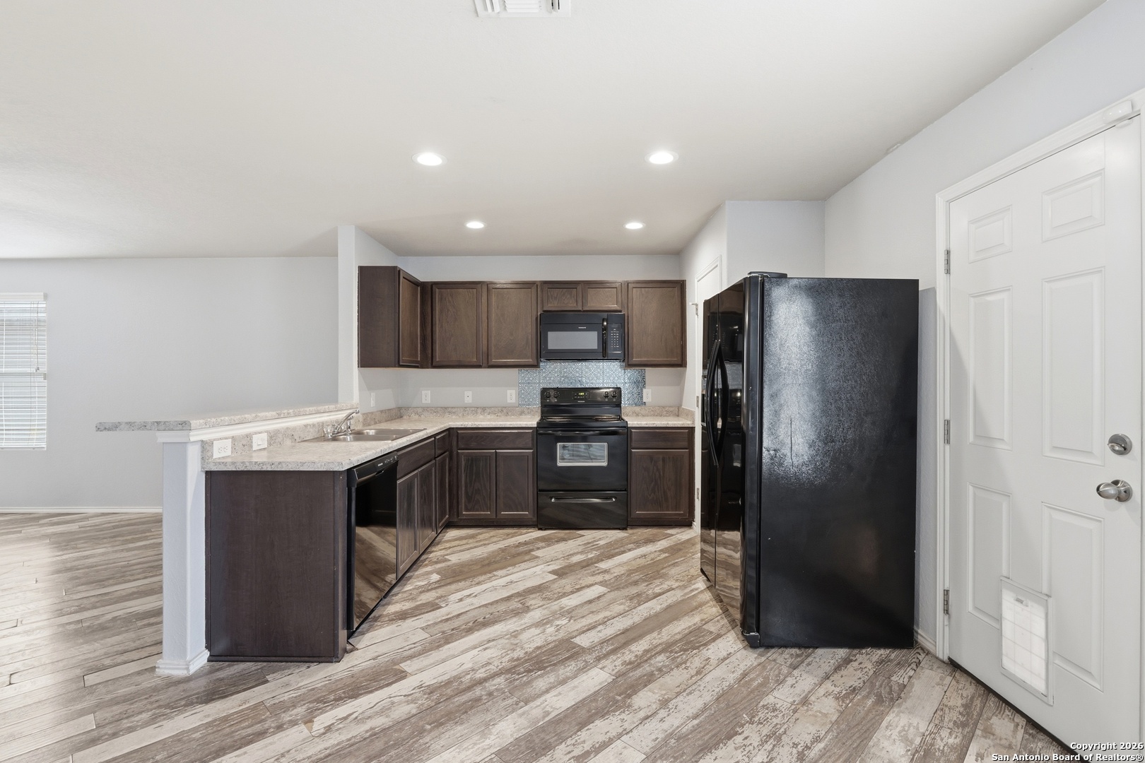 9713 Sandy Rdg Way San Antonio, TX 78239 - Photo 18 of 39 a kitchen with a refrigerator and a sink