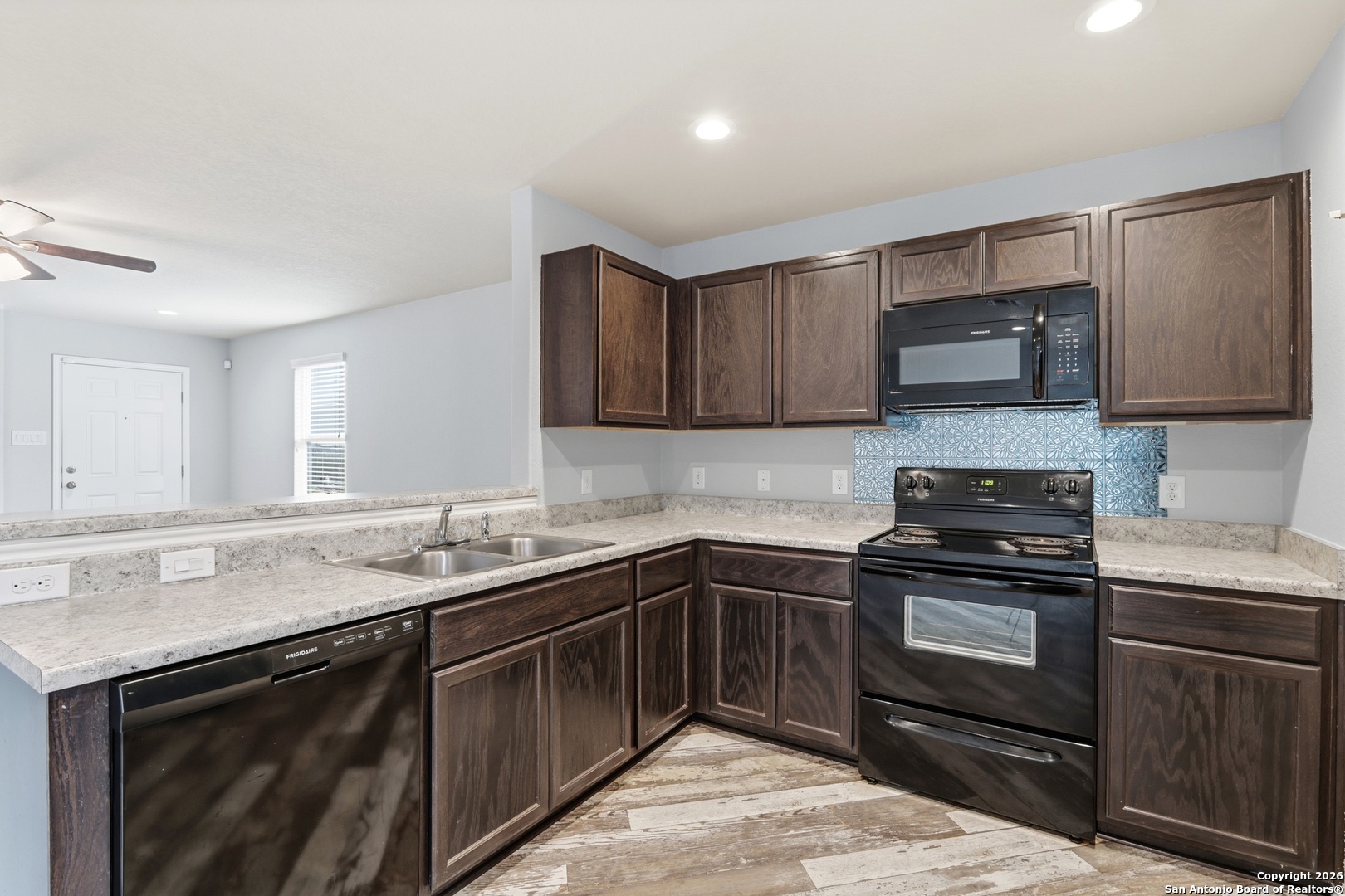9713 Sandy Rdg Way San Antonio, TX 78239 - Photo 19 of 39 a kitchen with stainless steel appliances granite countertop a sink stove and microwave