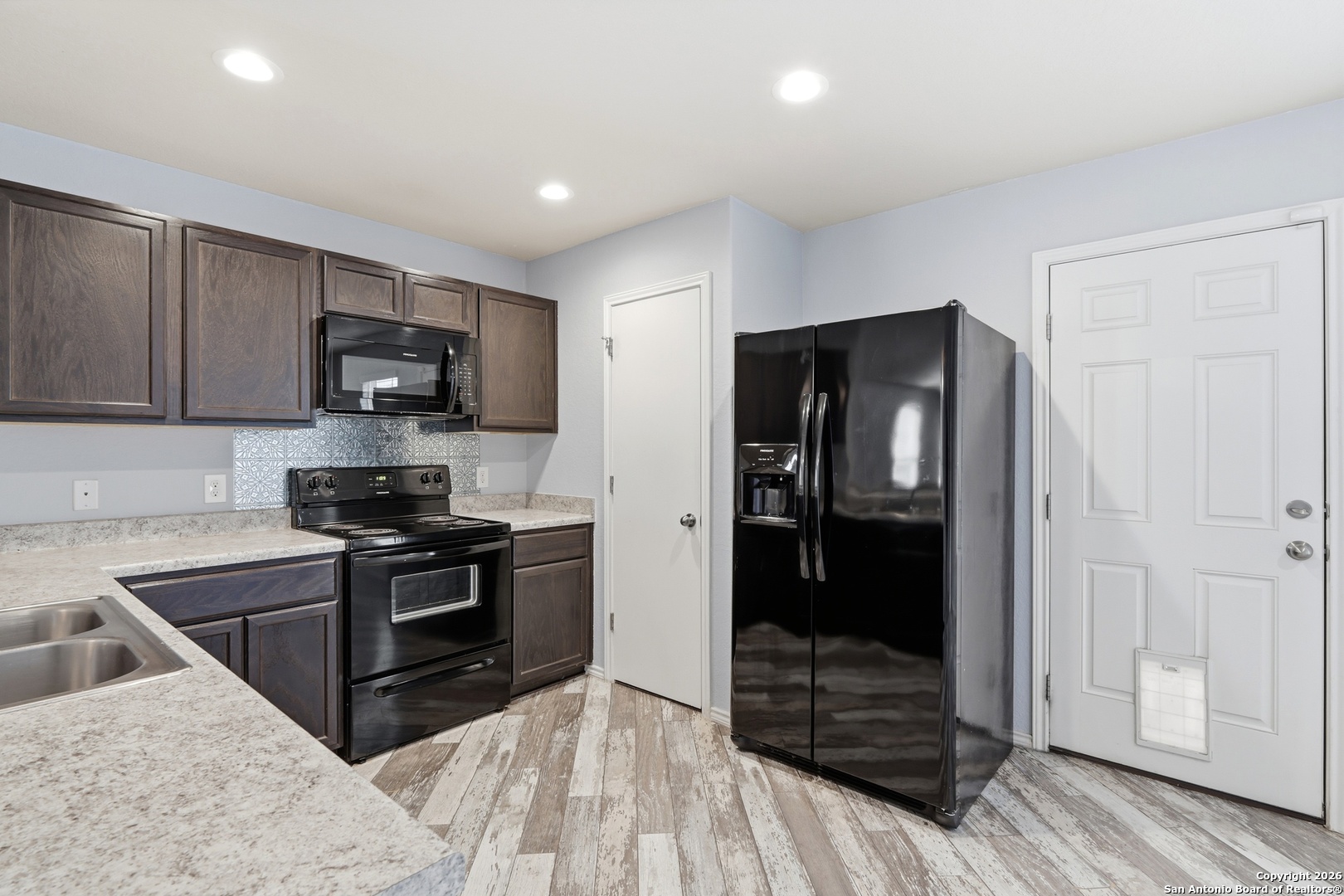 9713 Sandy Rdg Way San Antonio, TX 78239 - Photo 20 of 39 a kitchen with stainless steel appliances granite countertop a refrigerator and a stove top oven