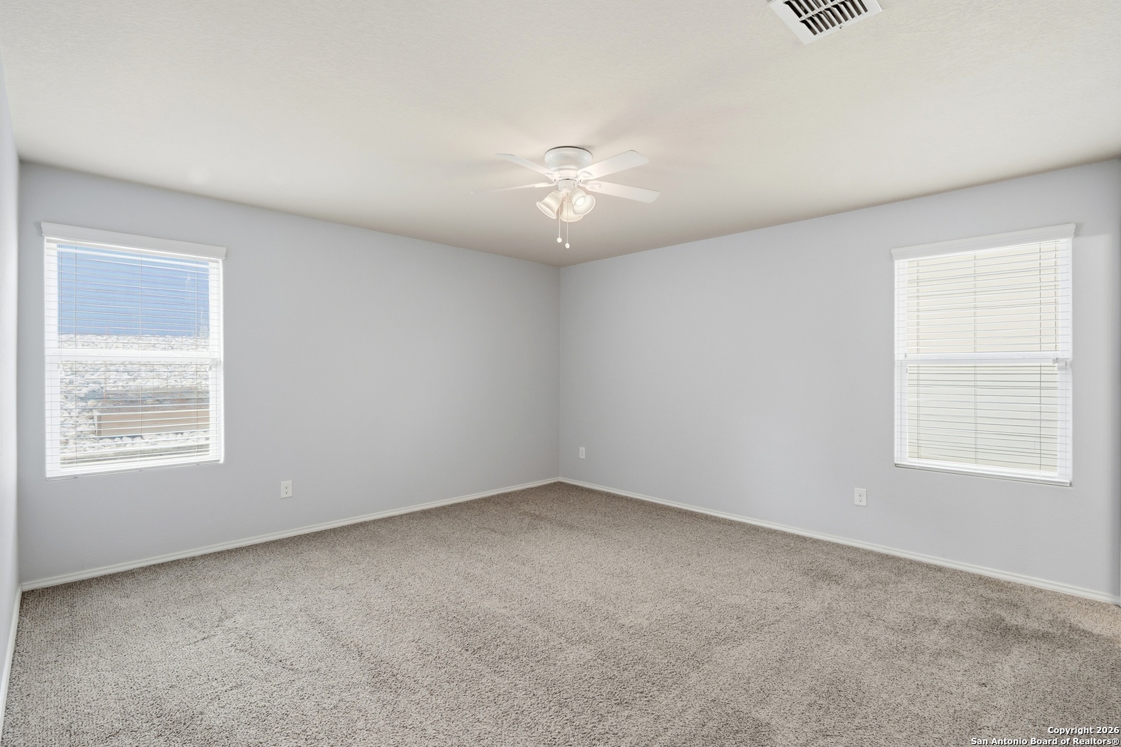 9713 Sandy Rdg Way San Antonio, TX 78239 - Photo 22 of 39 an empty room with a window and a ceiling fan