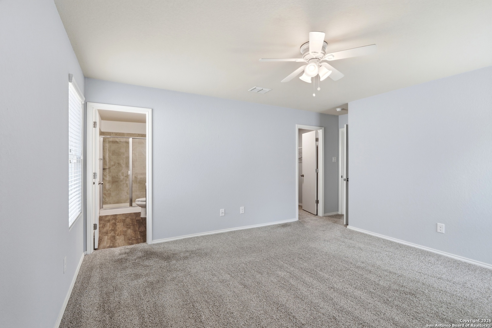9713 Sandy Rdg Way San Antonio, TX 78239 - Photo 23 of 39 an empty room with chandelier fan and windows