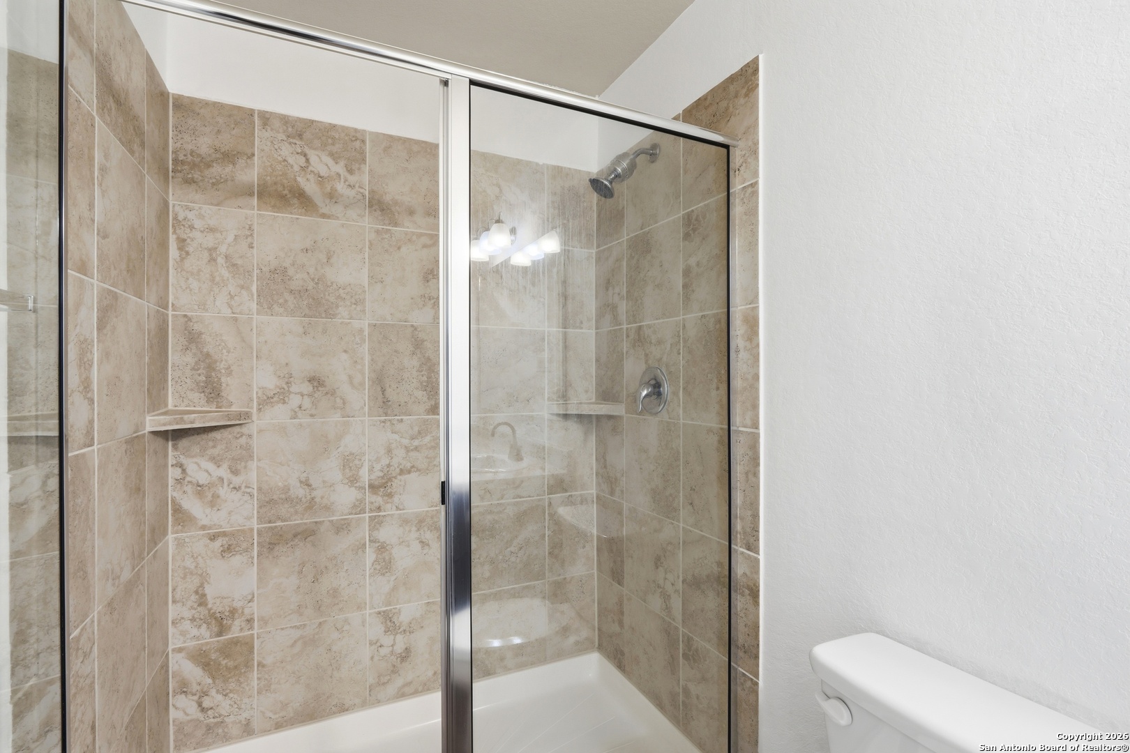 9713 Sandy Rdg Way San Antonio, TX 78239 - Photo 25 of 39 a bathroom with a shower and a toilet