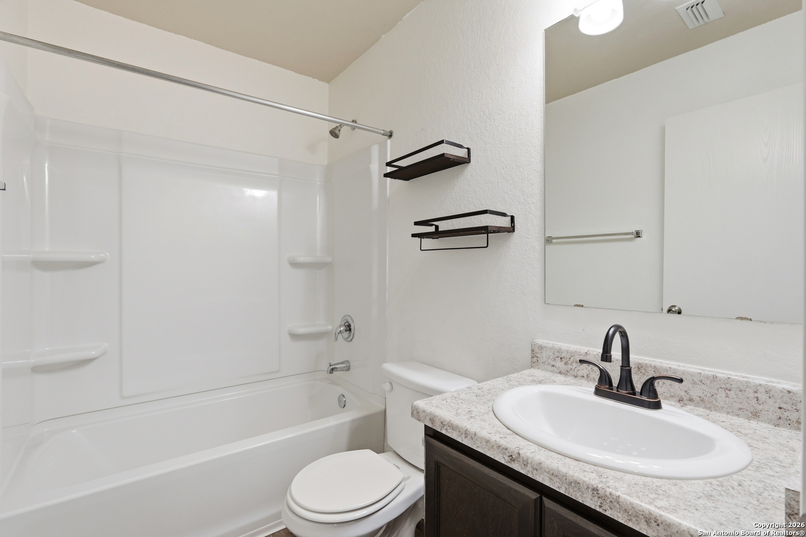 9713 Sandy Rdg Way San Antonio, TX 78239 - Photo 27 of 39 a bathroom with a granite countertop sink toilet and shower