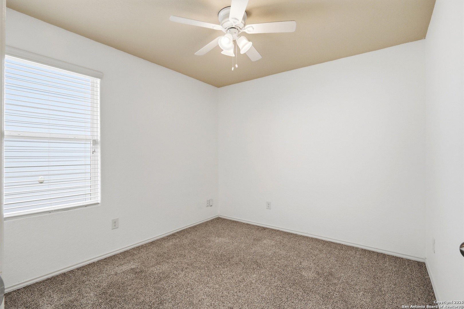 9713 Sandy Rdg Way San Antonio, TX 78239 - Photo 28 of 39 an empty room with a window and a ceiling fan