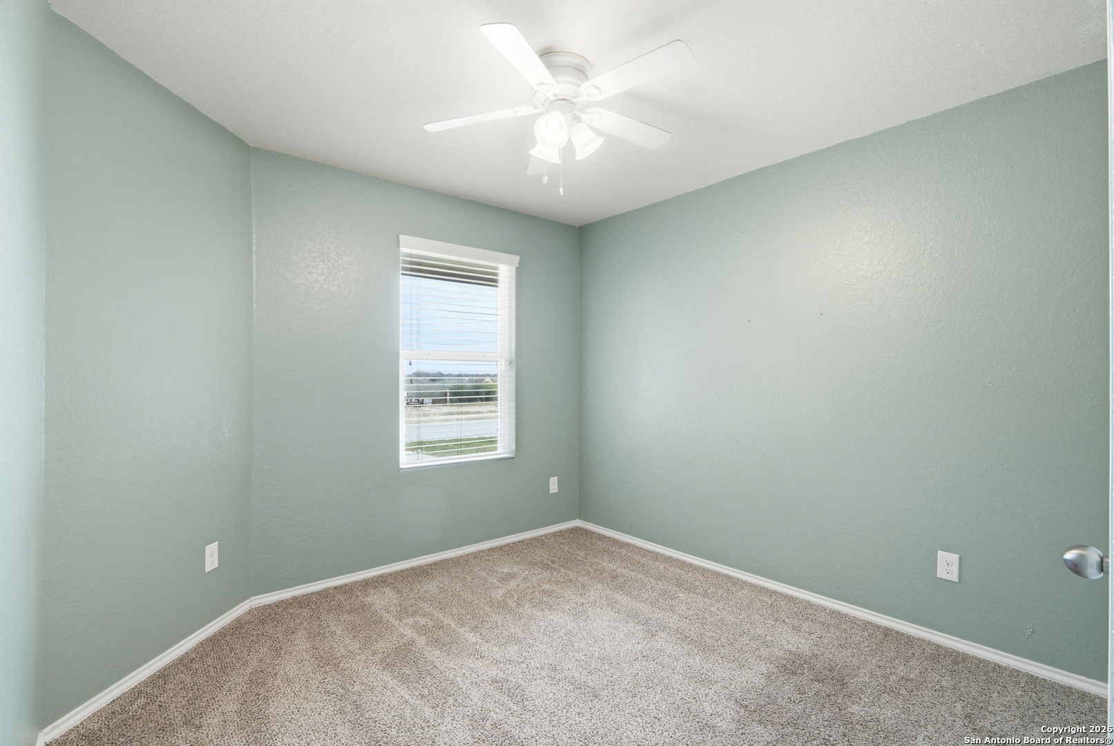 9713 Sandy Rdg Way San Antonio, TX 78239 - Photo 30 of 39 an empty room with a window and a fan