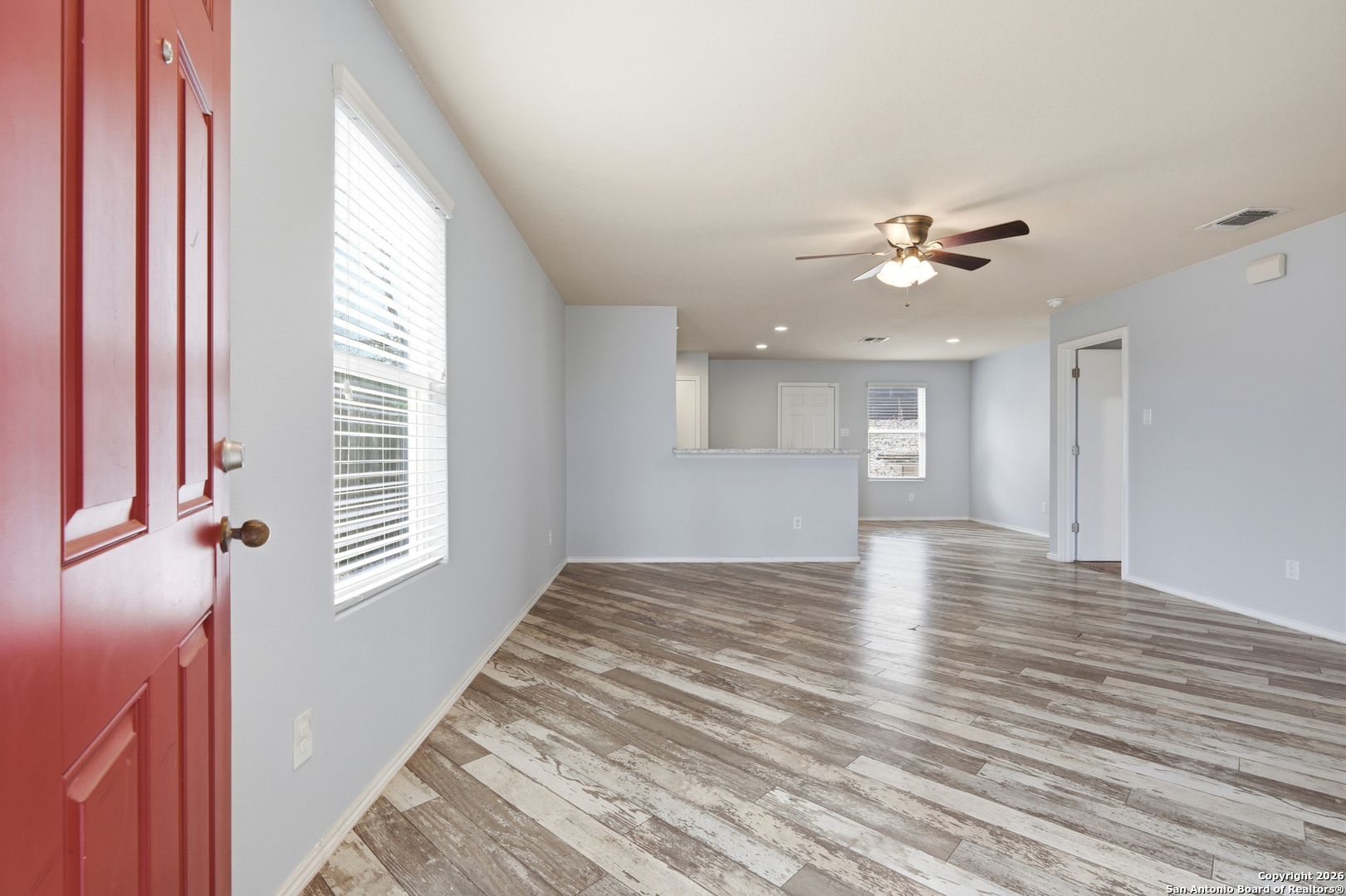 9713 Sandy Rdg Way San Antonio, TX 78239 - Photo 10 of 39 a view of an empty room with a window and wooden floor