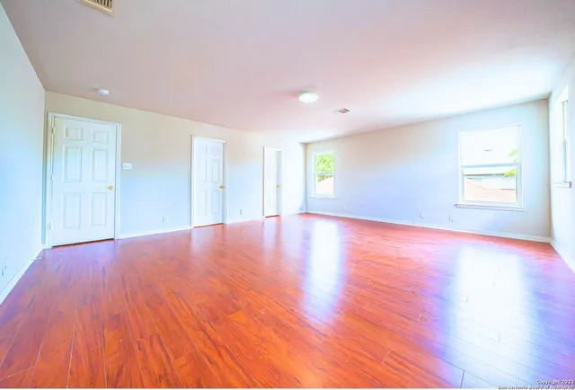a spacious bathroom with a sink a mirror and a shower