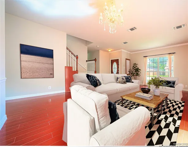 a large bedroom with bed and wooden floor