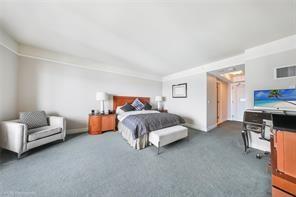 1435 Brickell Avenue, Unit 3211 Miami, FL 33131 - Photo 12 of 16 a spacious bedroom with a bed and a couch