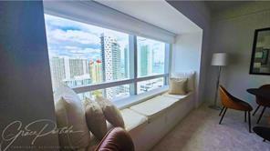 1435 Brickell Avenue, Unit 3211 Miami, FL 33131 - Photo 14 of 16 a living room with furniture and a large window