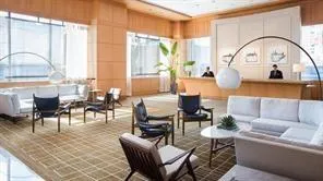 a living room with furniture a large window and a dining table